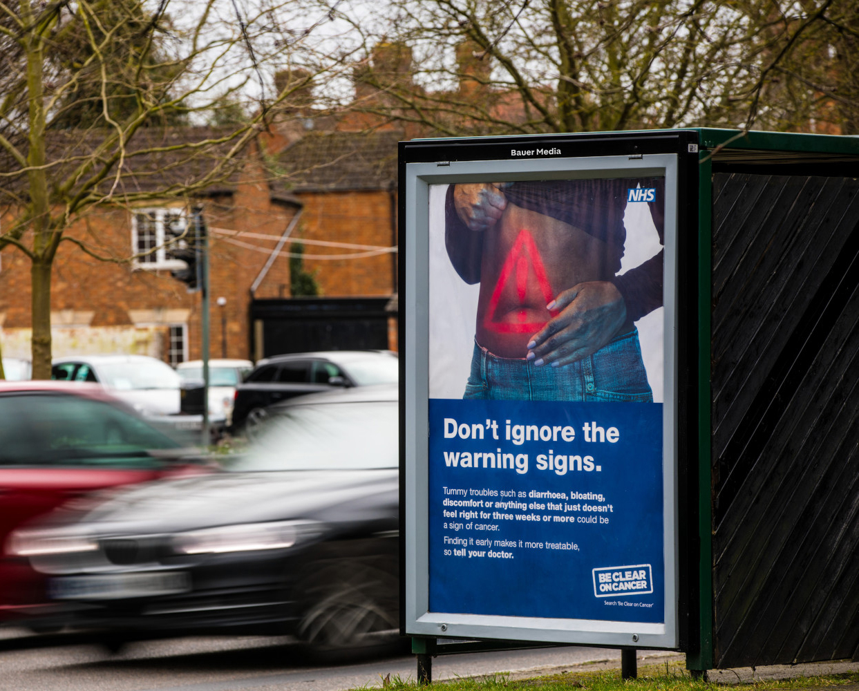 NHS Cancer campaign on a bus stop poster