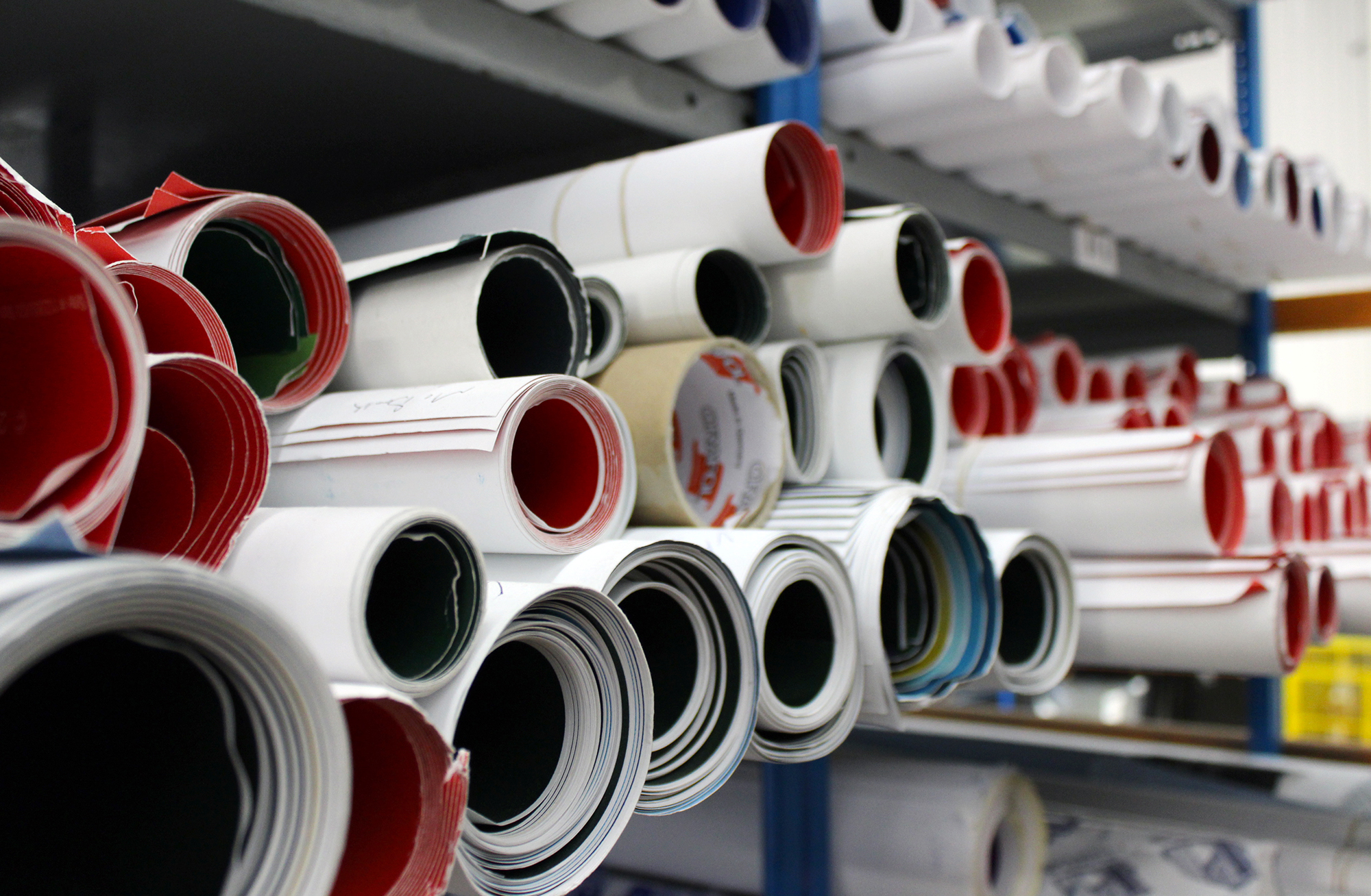 Warehouse worker sorting advertising posters