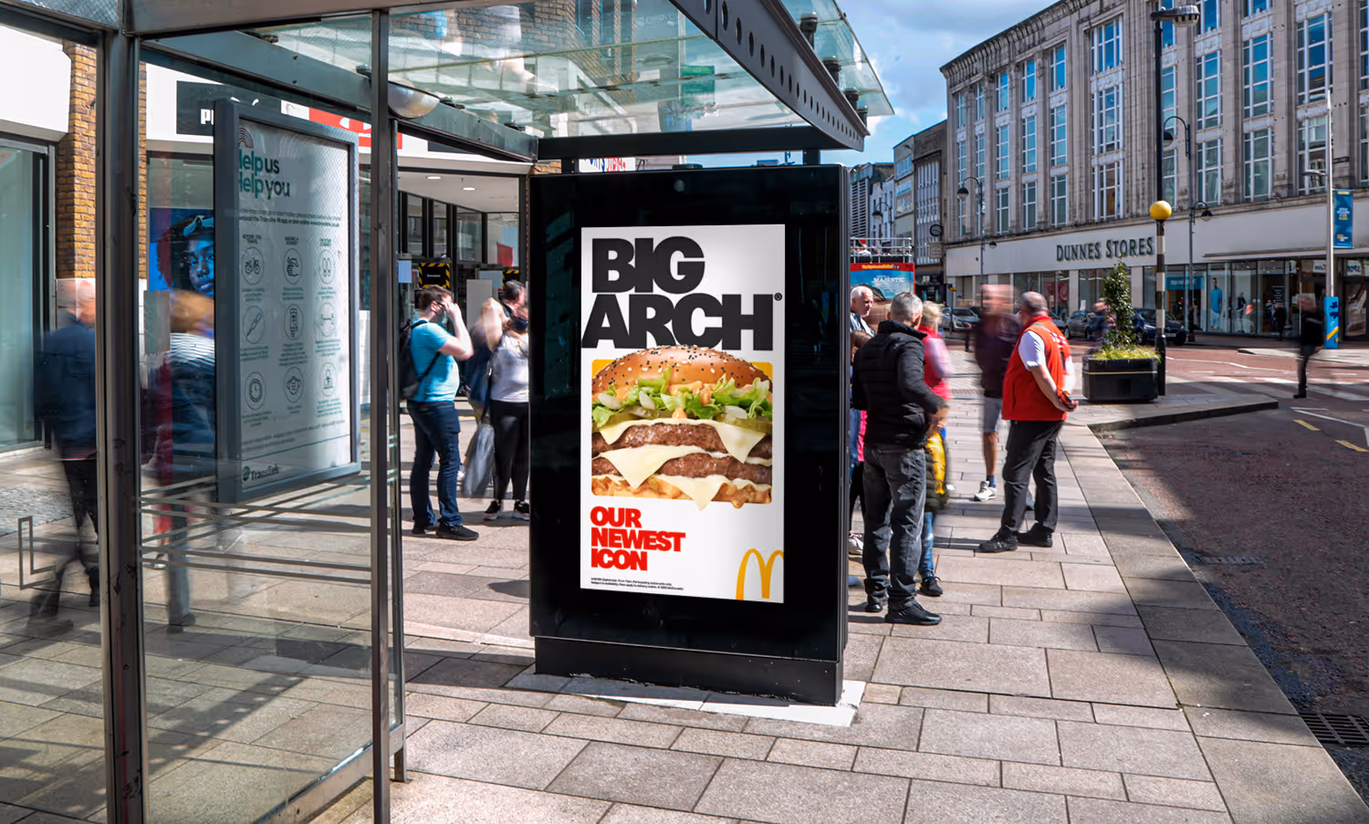 An Adshel Live digital bus shelter located on a busy shopping street full of people