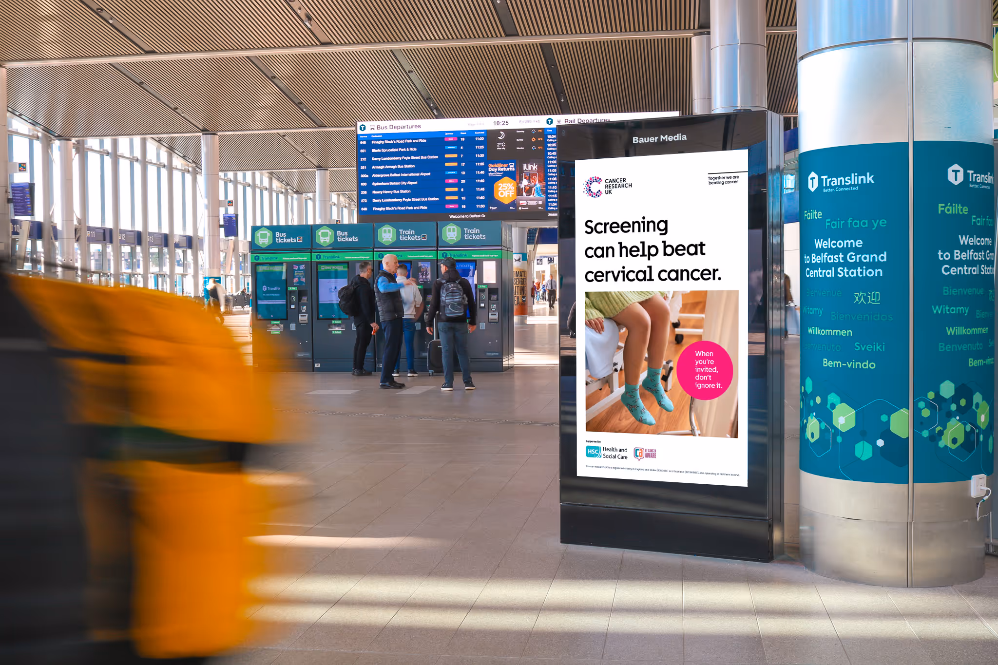 A digital screen advertisement in a busy train station