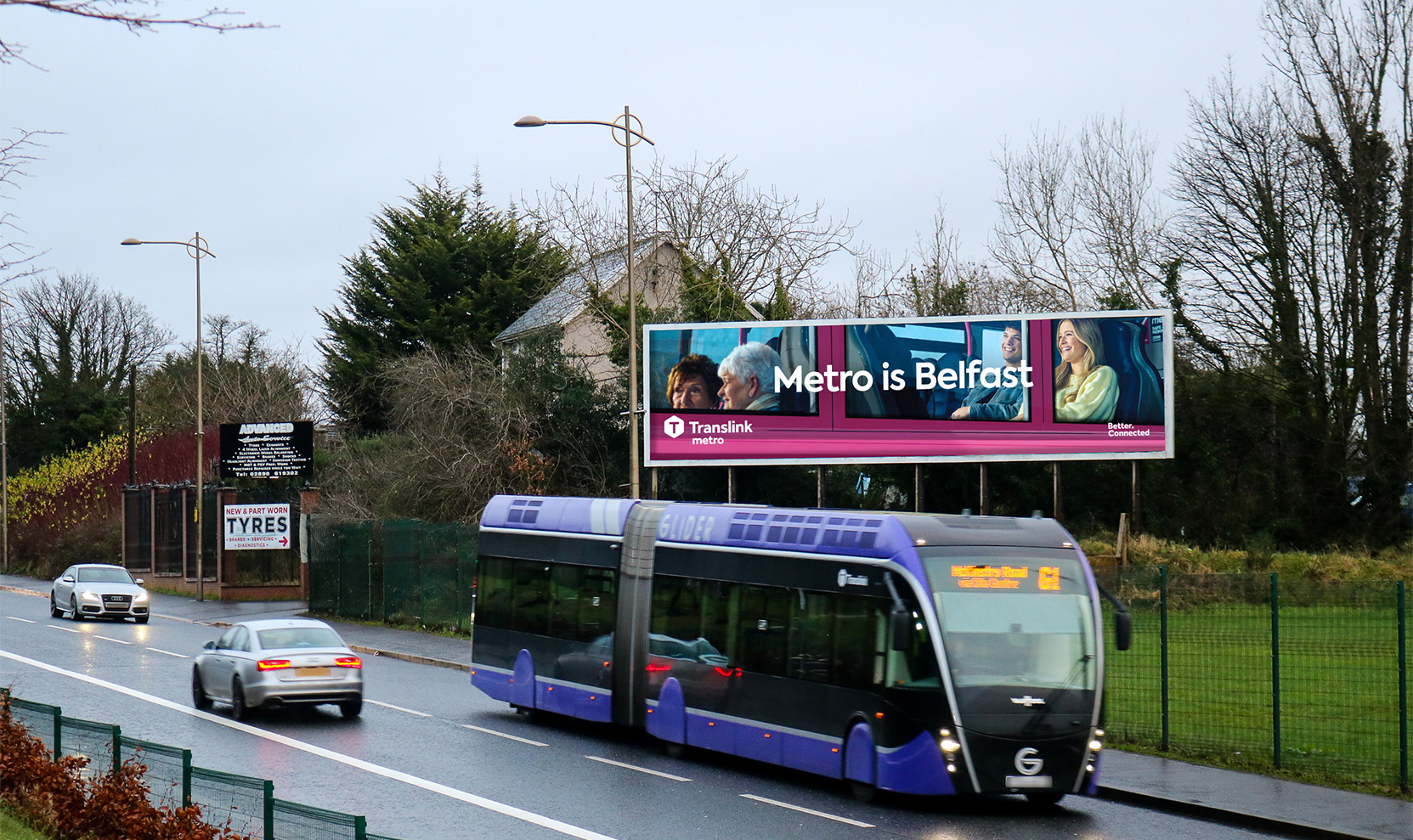 A 96-sheet billboard advertisement overlooking a busy road with traffic passing by