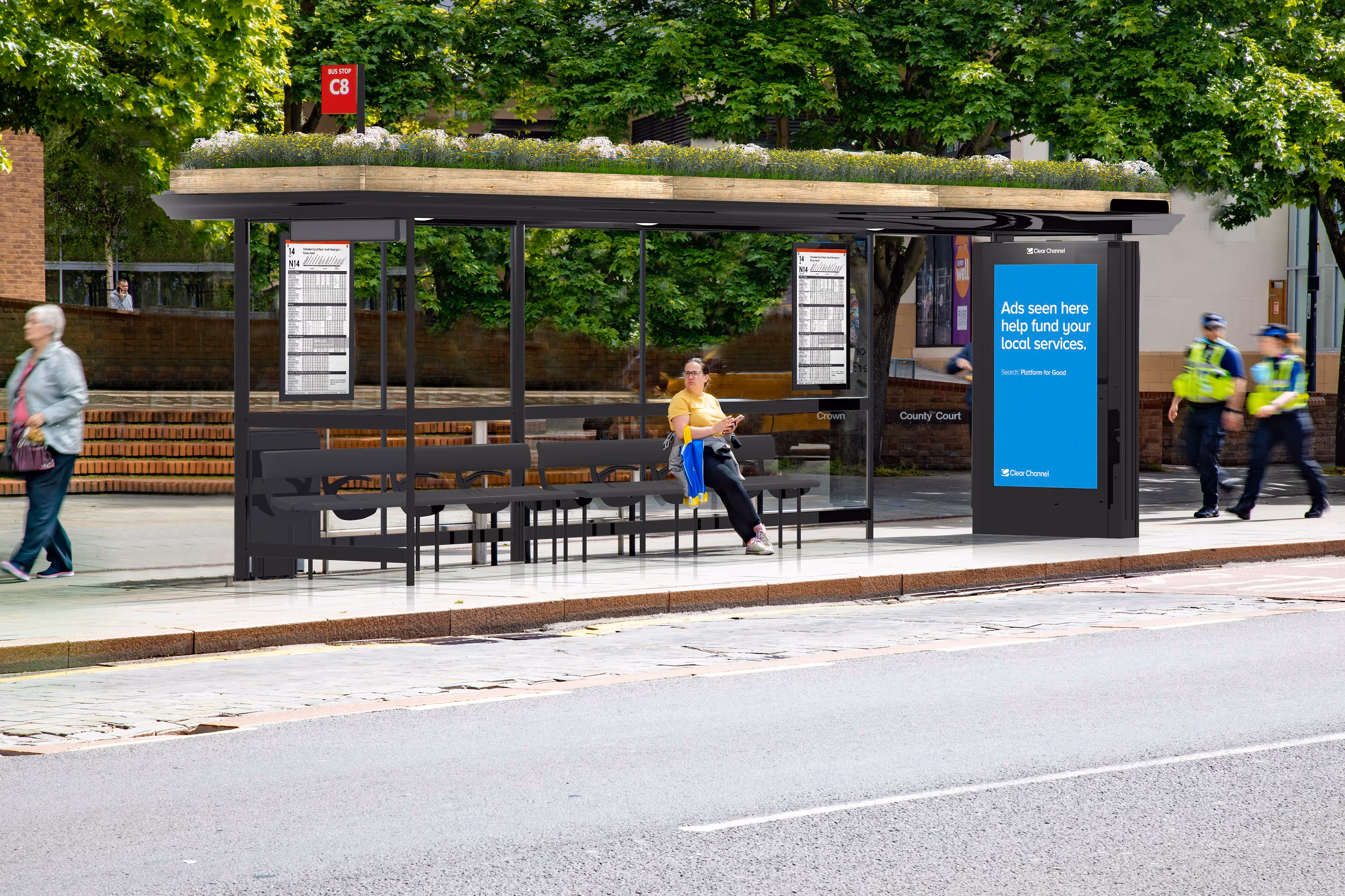 A render of a bus shelter, featuring a Living Roof on top, on a sidewalk in Derby as pedestrians pass by during the day