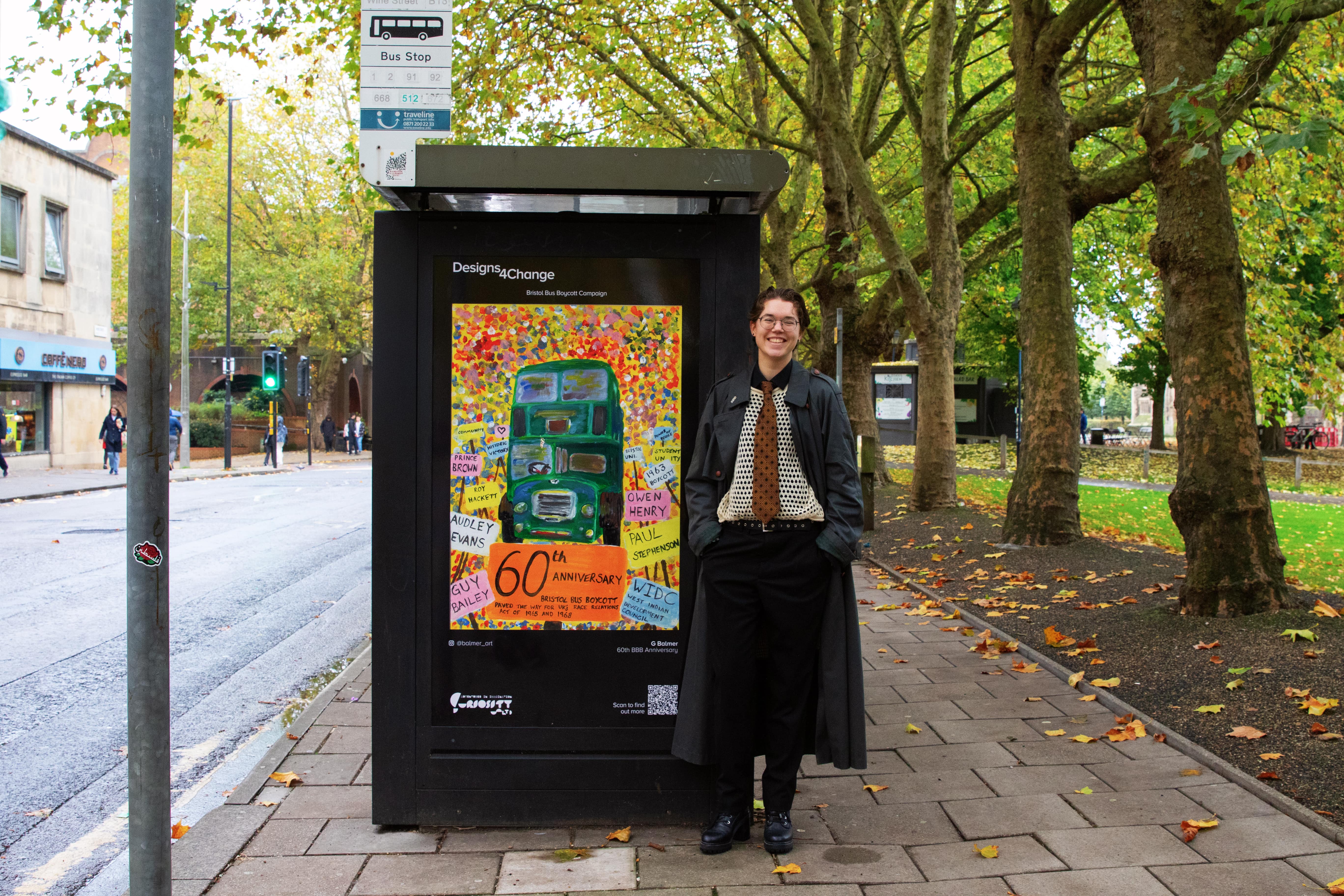 Gwen Balmer at a bus stop displaying their winning image during the day