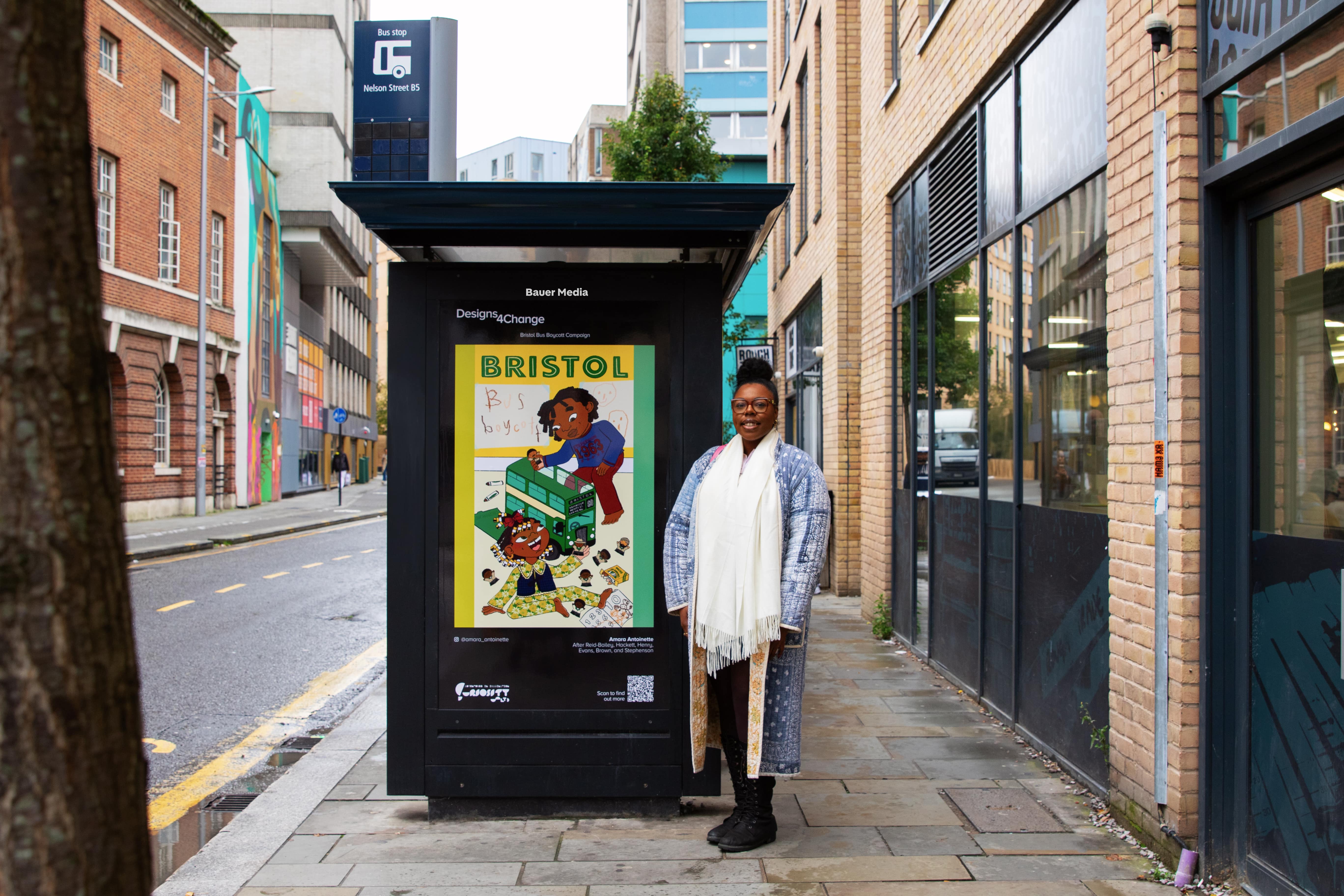 Amara Antoinette at a bus stop displaying her winning image during the day