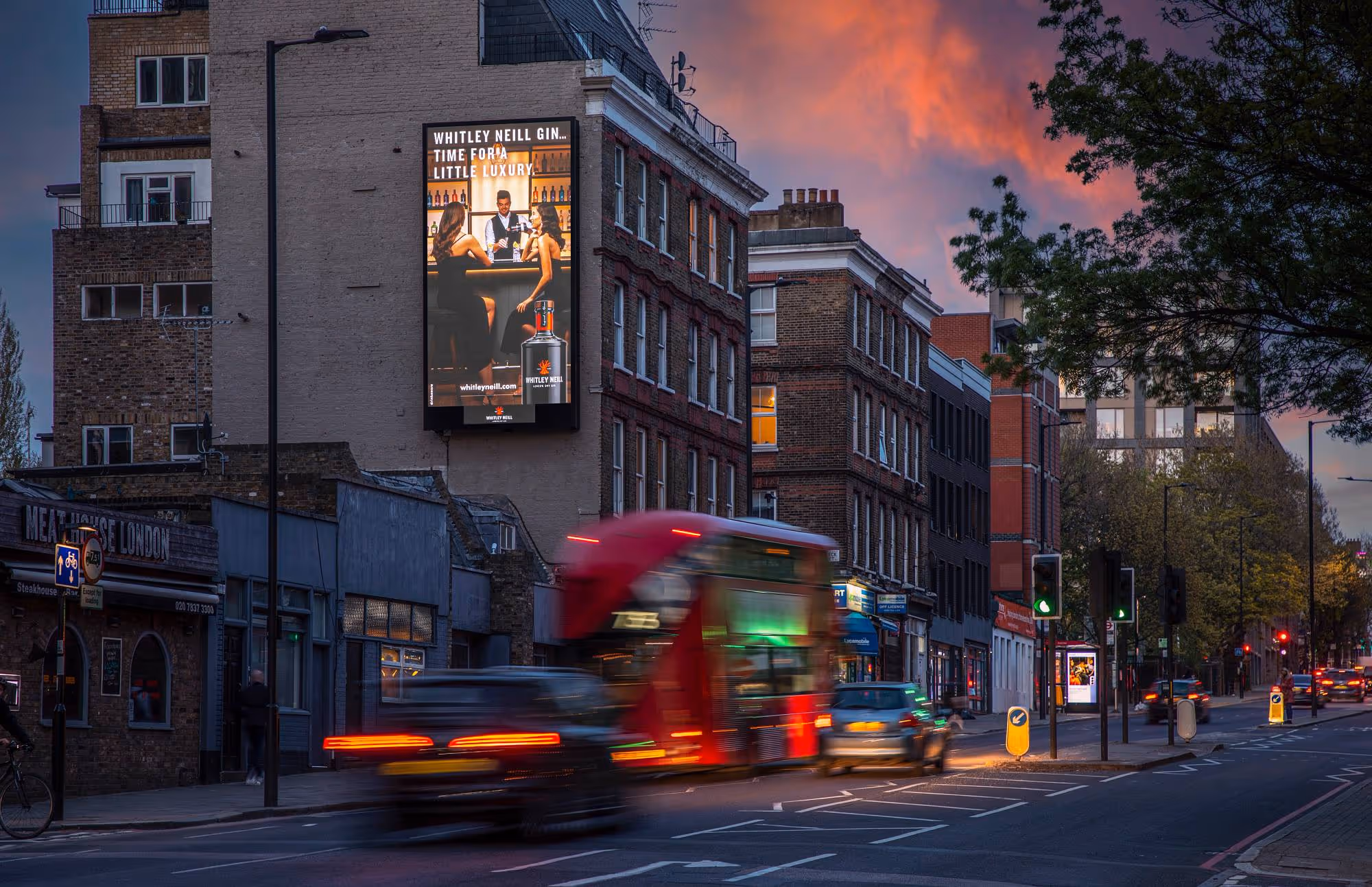 Bauer Media Outdoor Storm digital screen at Kings Cross showing ad for Whitley Neil gin