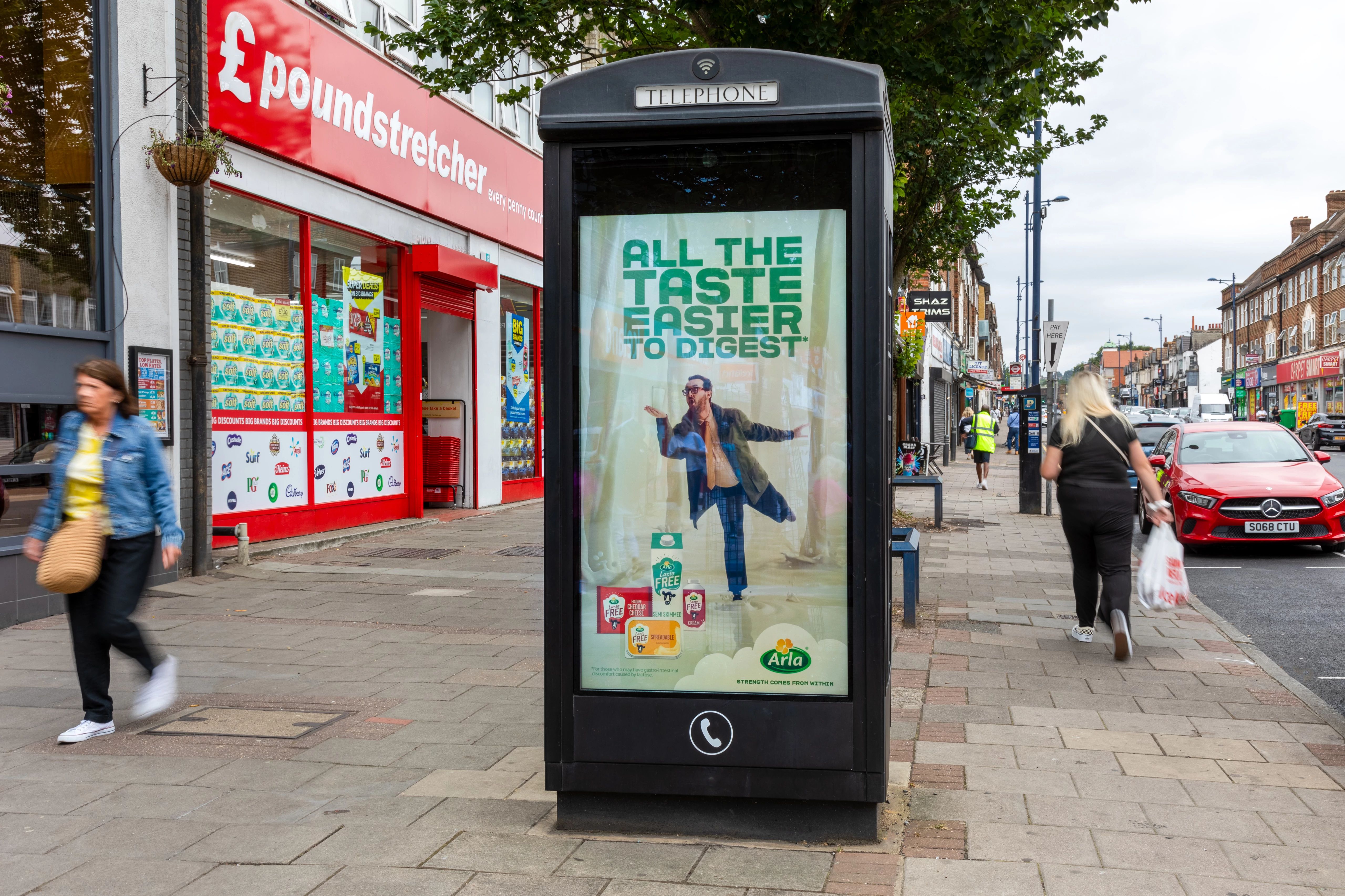 Arla product ad on an Adshel Live screen on a phone kiosk