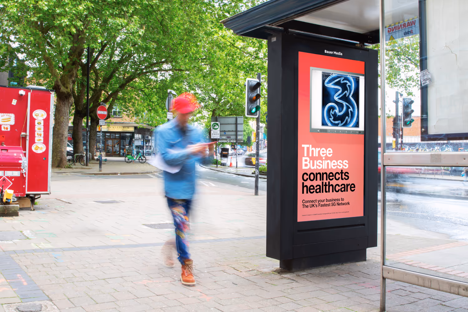 Three Mobile ad on an Adshel Live screen on a bus shelter