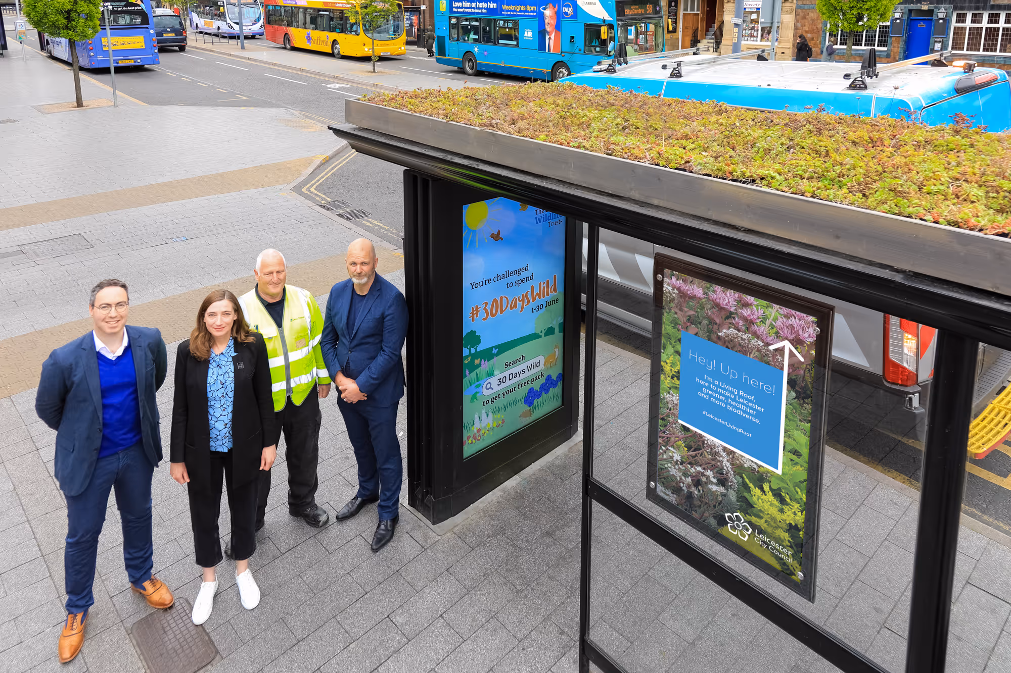 Aerial Shot of Bauer Media and Wildlife Trust employees standing next to a living roof