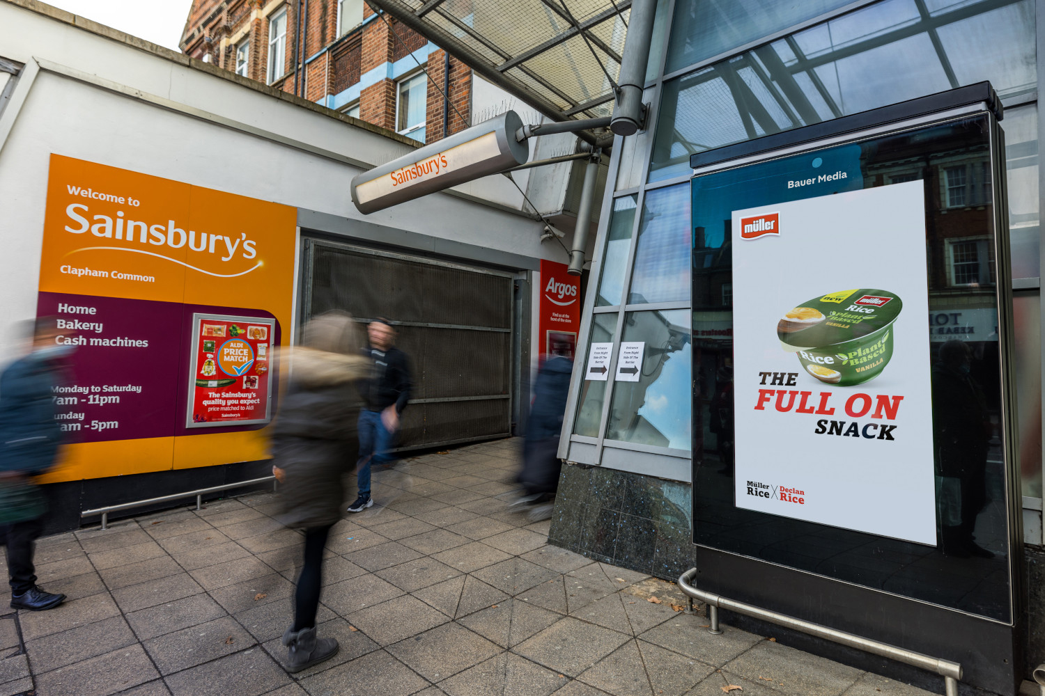 Image of Muller's digital out of home campaign of their new plant based yoghurt on a panel outside of Sainsbury's