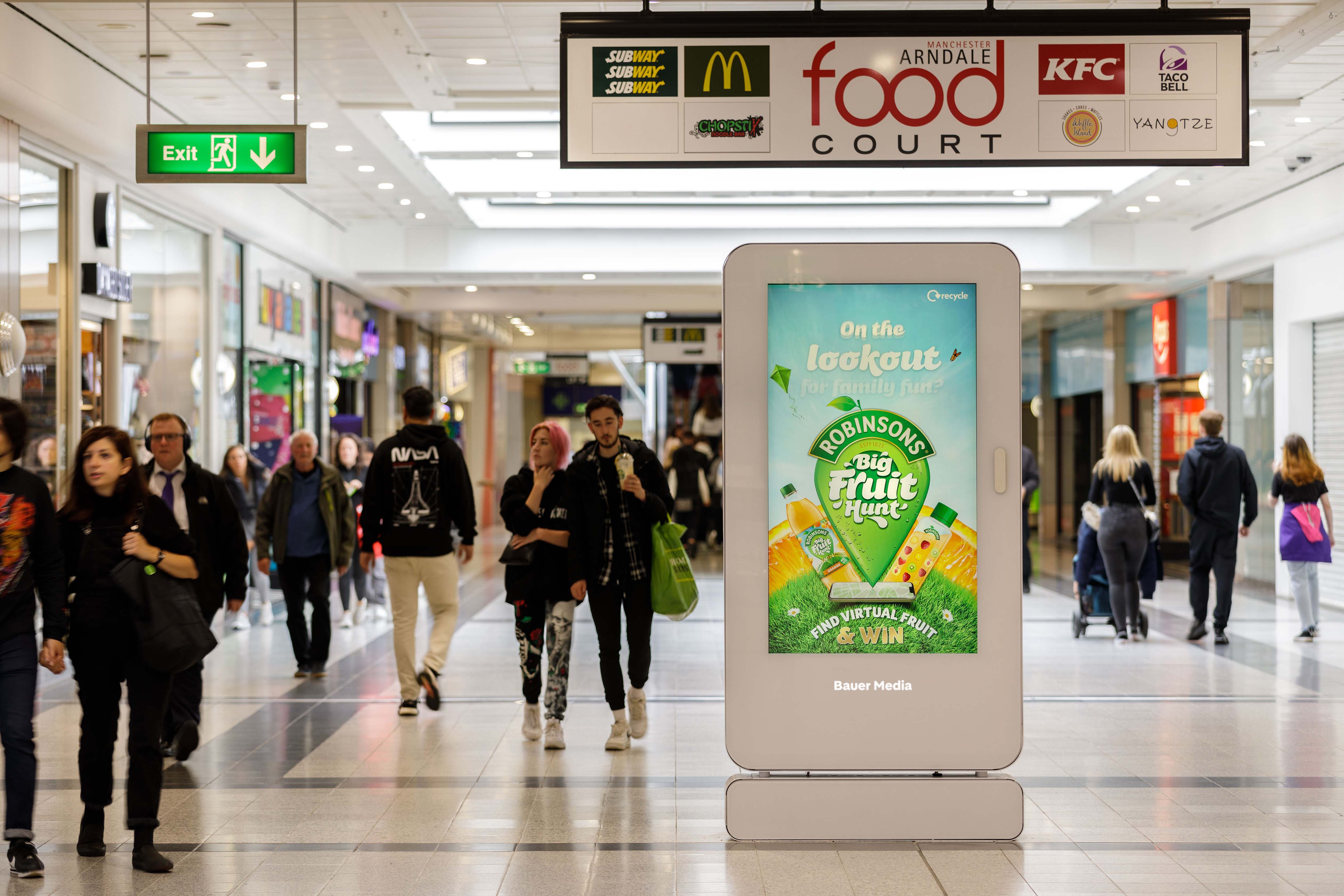 A digital screen in a shopping mall displaying an ad for Robinsons