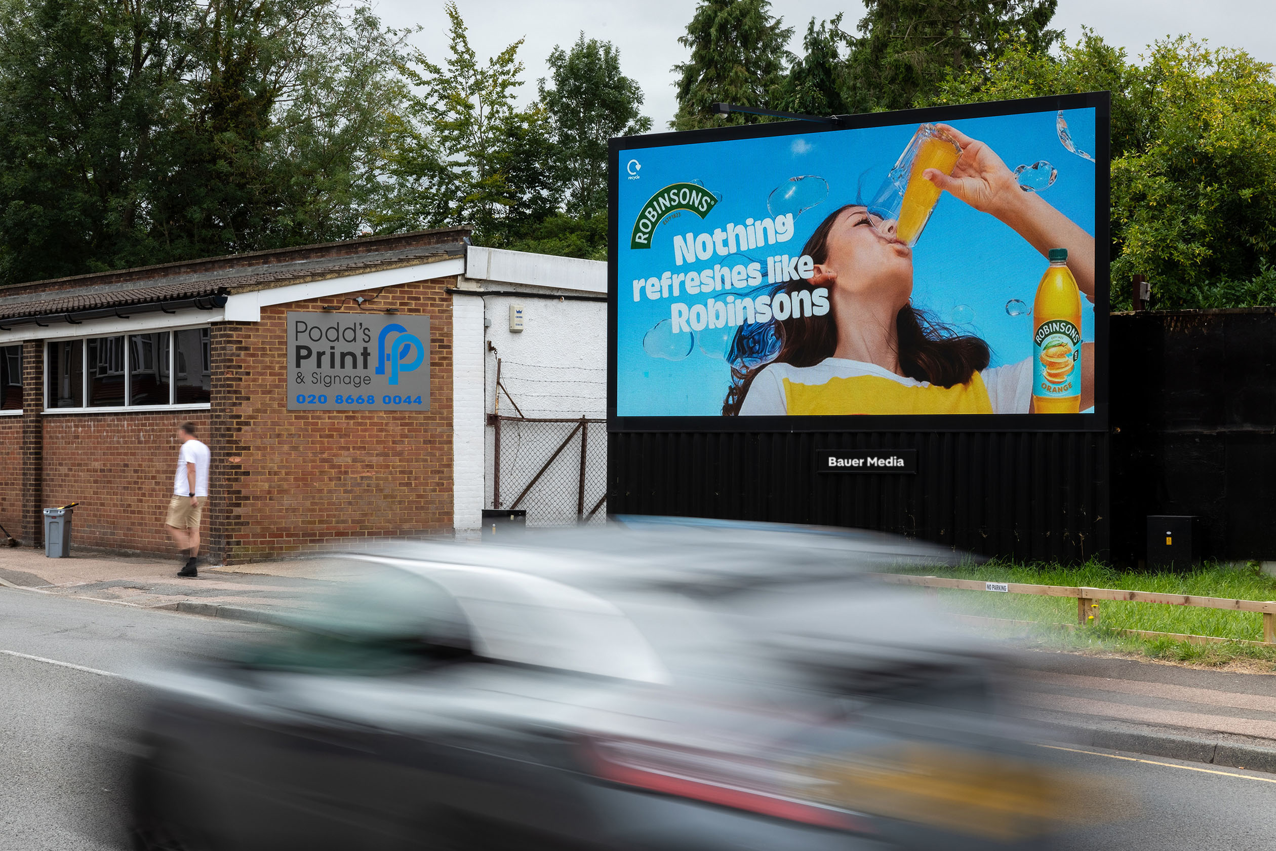 A digital billboard showing an ad for Robinsons