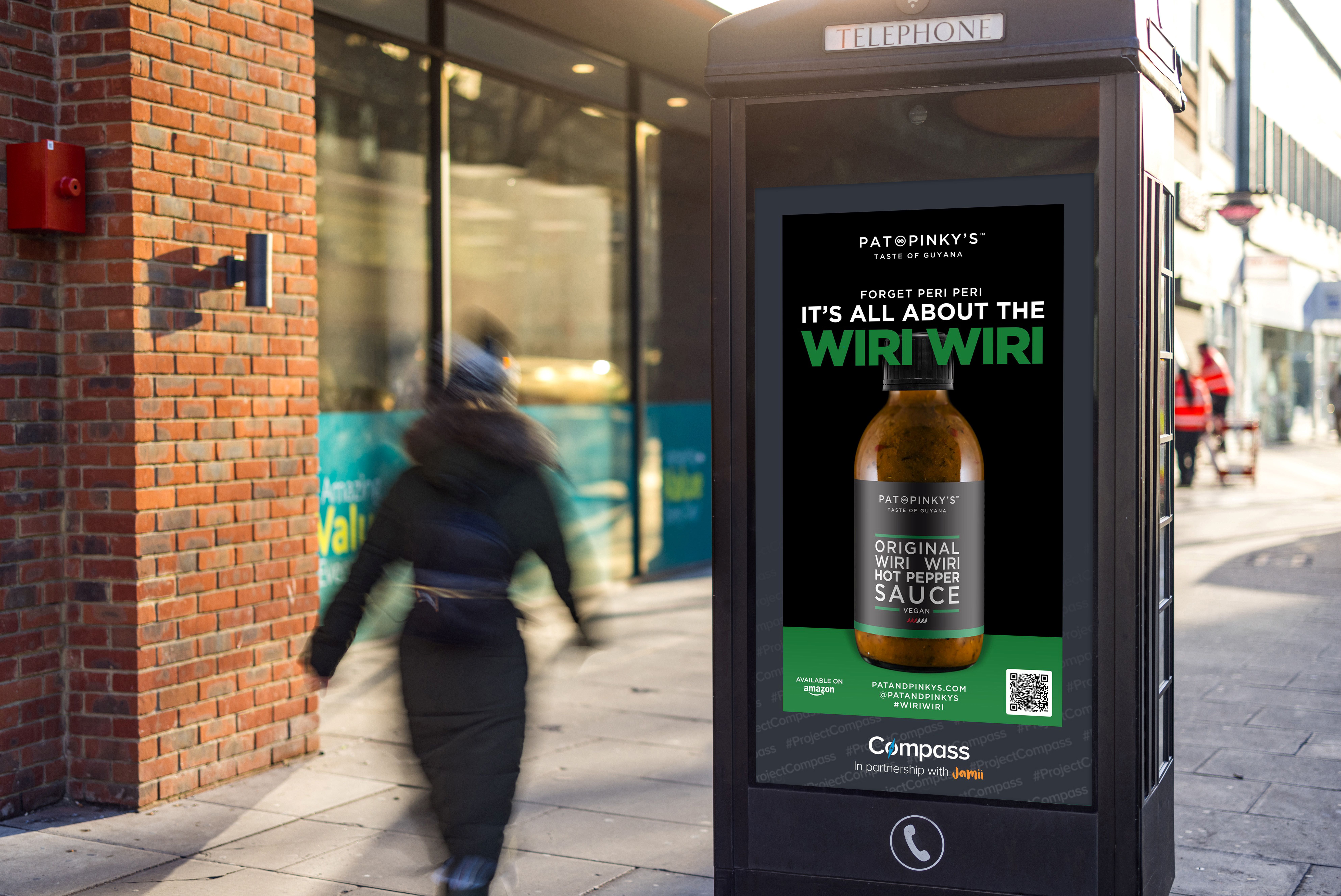 An advertising screen on a phone kiosk showing an advert for a Black-owned business that previously won the Compass scheme