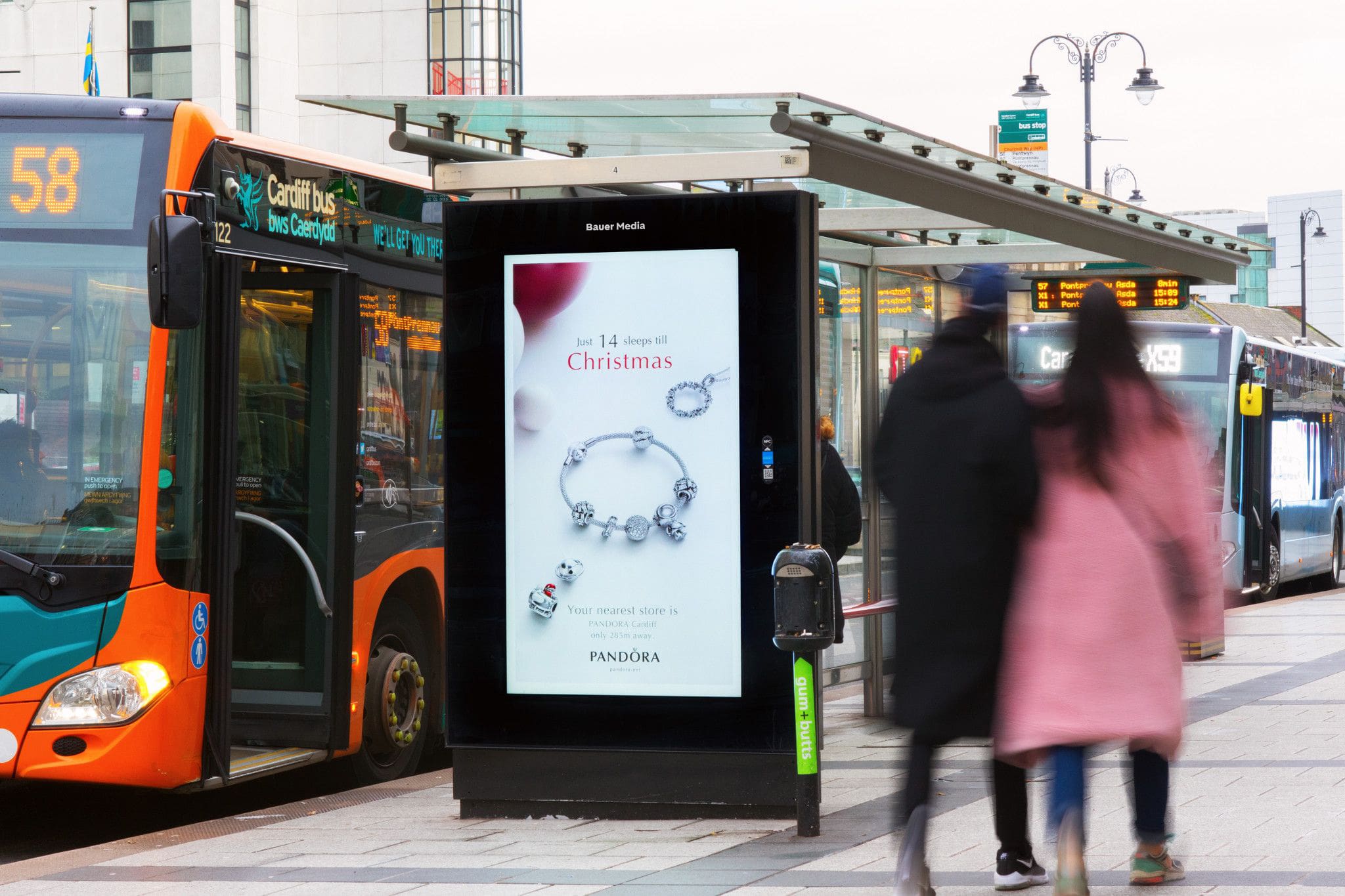 A Pandora Christmas campaign on a digital bus stop