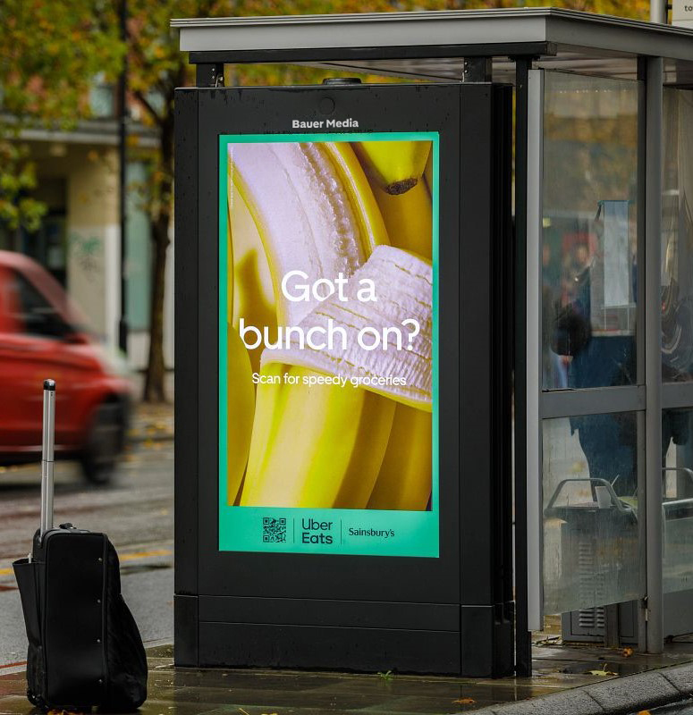 Uber Eats advertising on a digital bus shelter screen