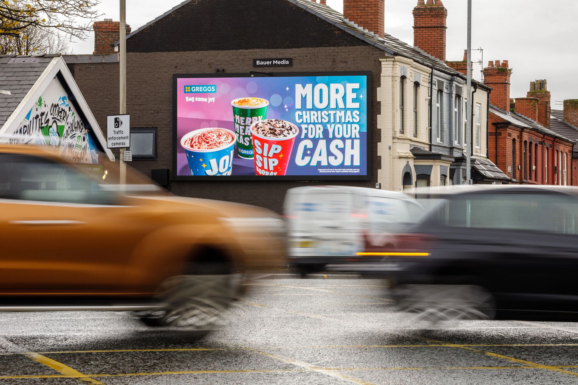 A Greggs Christmas campaign on a digital billboard