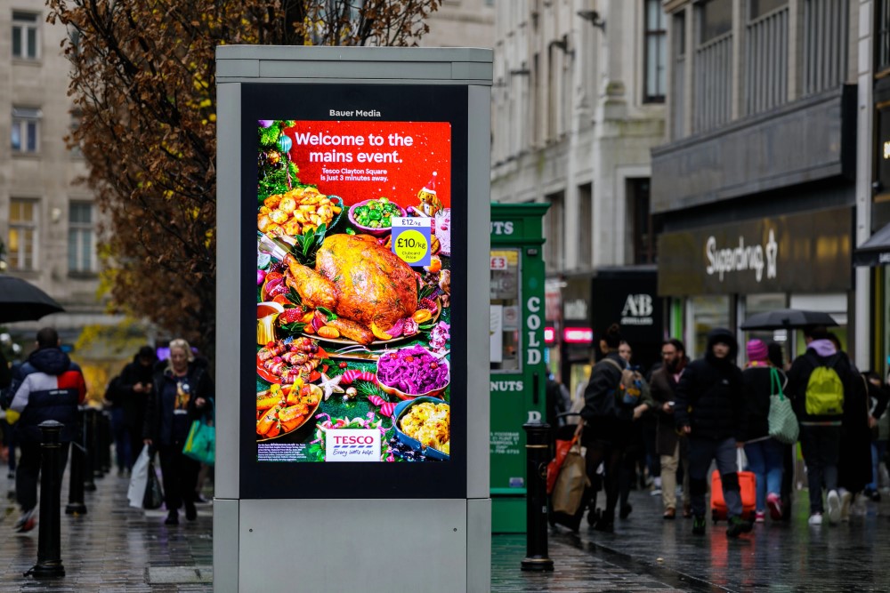 Tesco's advertising their Christmas day creative on a high street digital screen