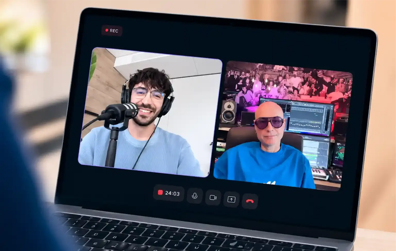 open laptop showing an interview recording and 2 men talking