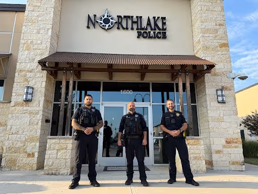 Three police officers are positioned outside Northlake Plaza