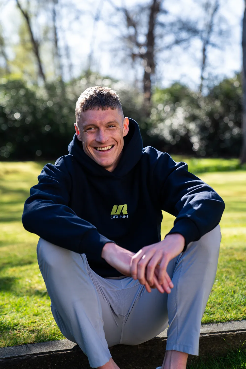 Adam Clarke sitting on grass
