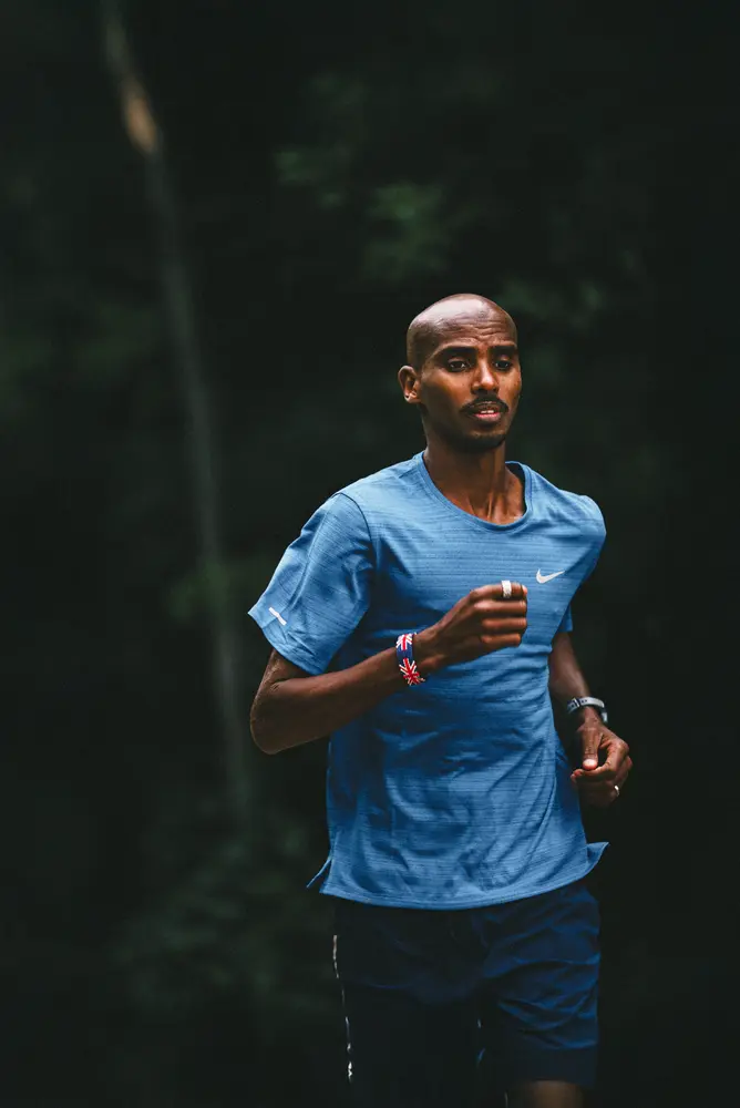 Sir Mo Farah running in blue shirt