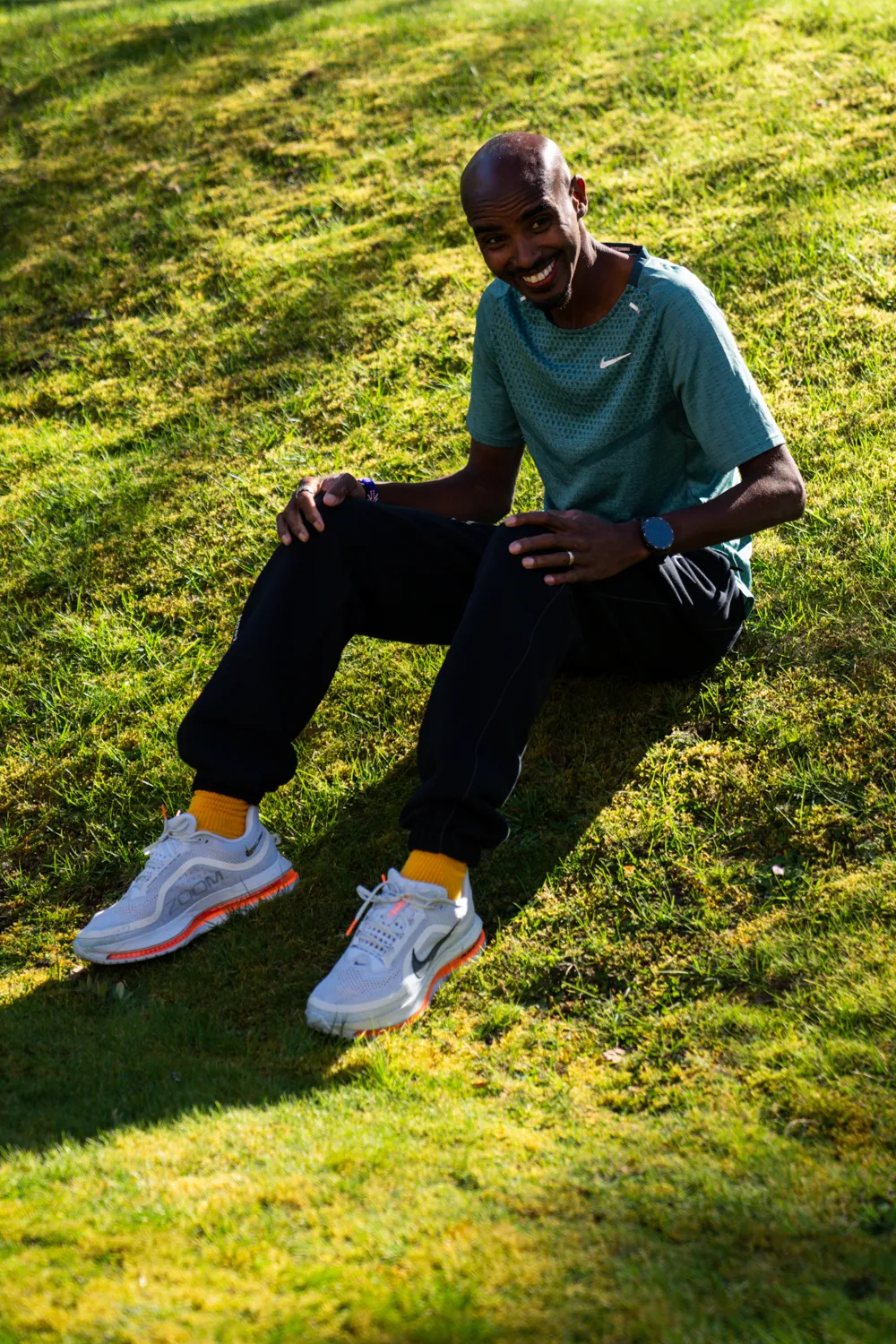 Sir Mo Farah sitting on grass