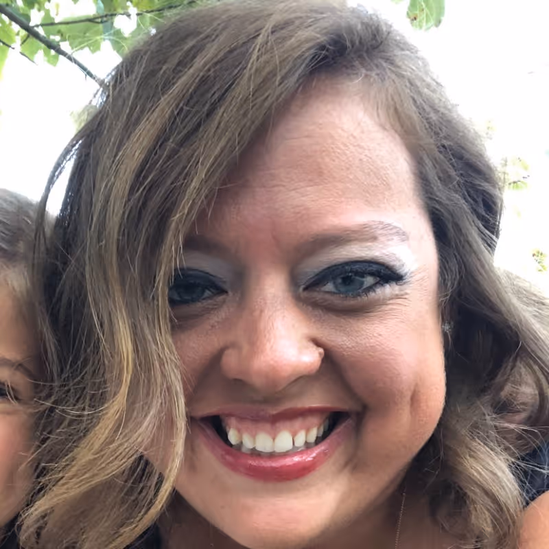 Smiling woman close-up portrait outdoors.