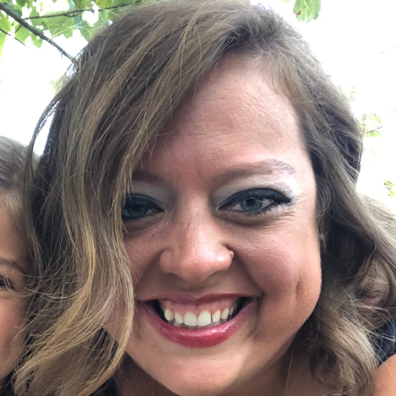 Smiling woman close-up portrait outdoors.