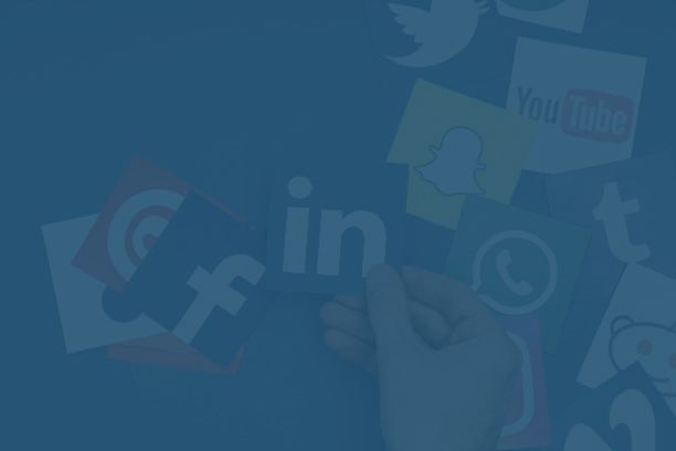 Mini shopping cart with smartphone displaying 'PAY' and credit cards, shopping bags, and boxes on a laptop showing 'ONLINE SHOPPING' text.