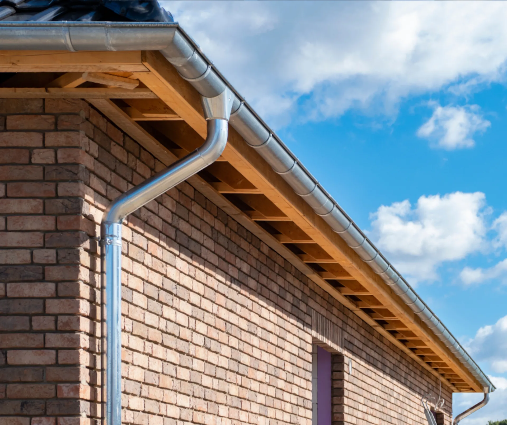 aluminum gutter and downspout system on a new brick home