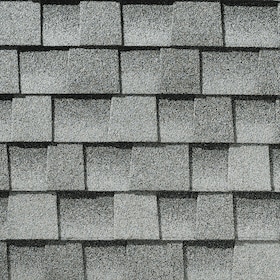 Close-up of gray asphalt roof shingles arranged in overlapping rows.