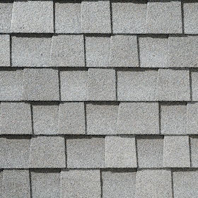 Close-up view of gray asphalt roof shingles arranged in a staggered pattern.