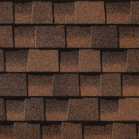 Close-up of brown asphalt roofing shingles arranged in overlapping rows.