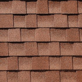 Close-up of layered reddish-brown asphalt roof shingles.