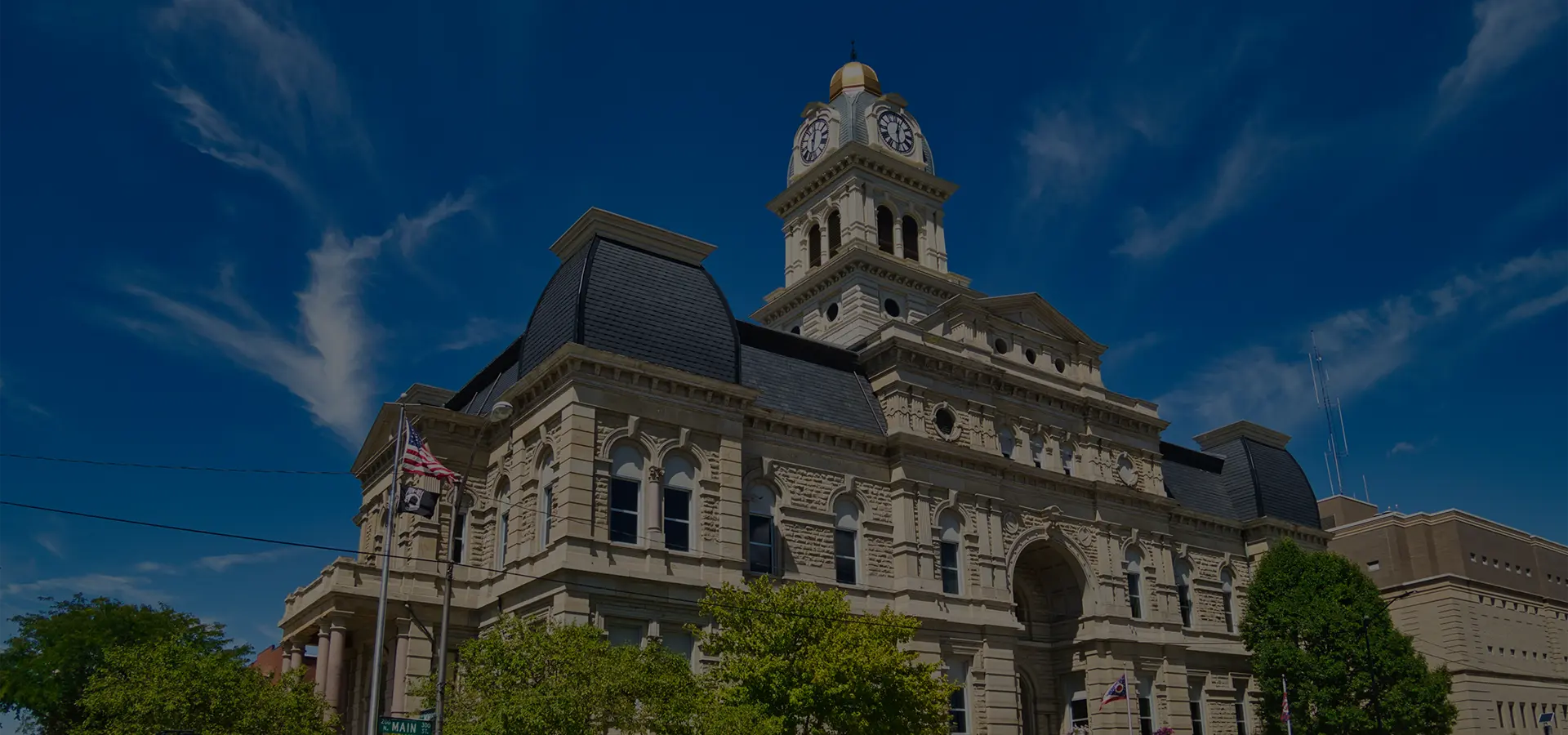 Historic courthouse building with clock tower under a clear blue sky.