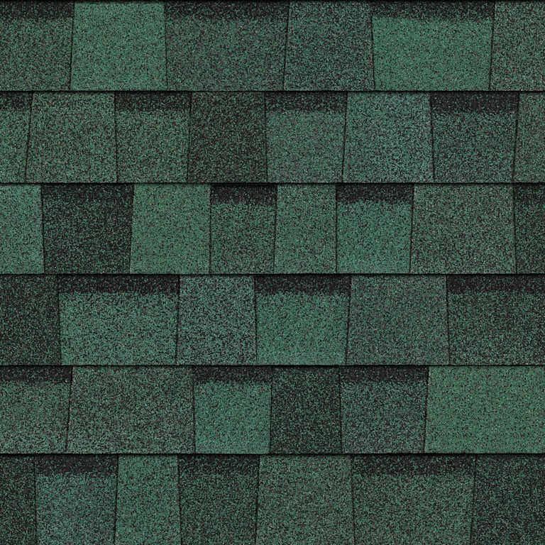 Close-up of green roofing shingles arranged in overlapping rows.