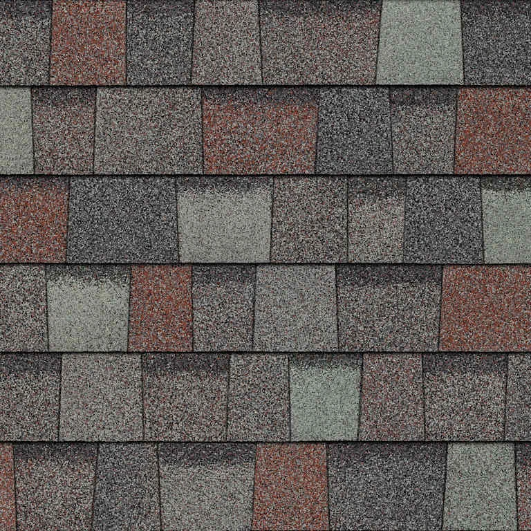 Close-up of multi-colored asphalt roof shingles with gray, brown, and reddish tones in a staggered pattern.