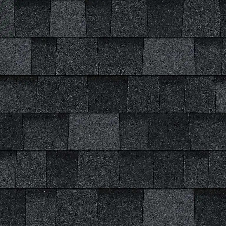 Close-up of dark gray and black asphalt roof shingles arranged in rows.