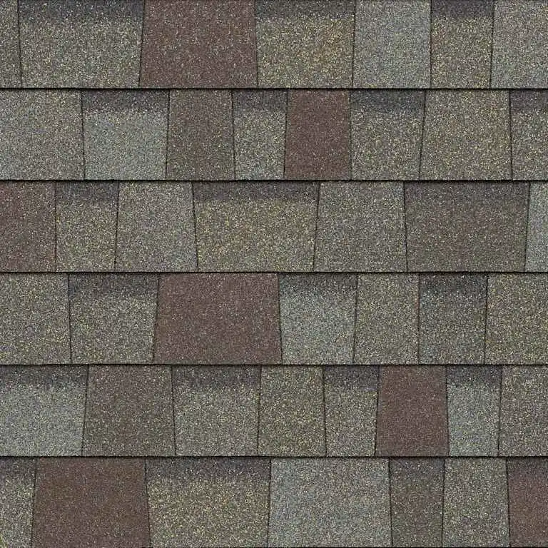 Close-up of multicolored asphalt roof shingles arranged in a staggered pattern.