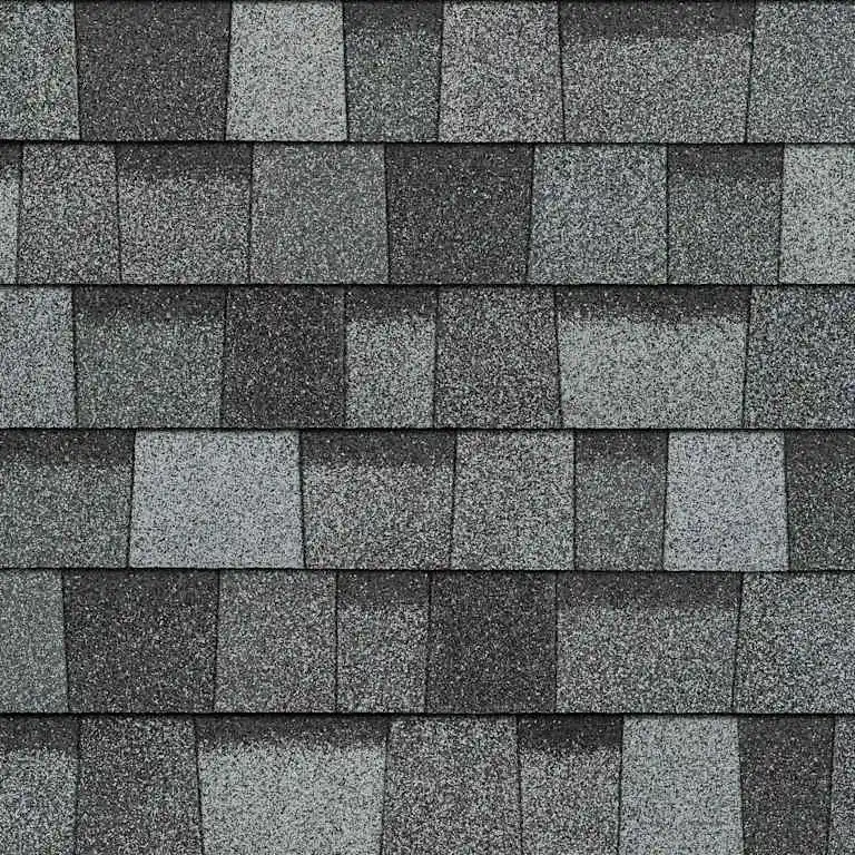 Close-up of gray slate stone shingles arranged in horizontal overlapping rows on a roof.