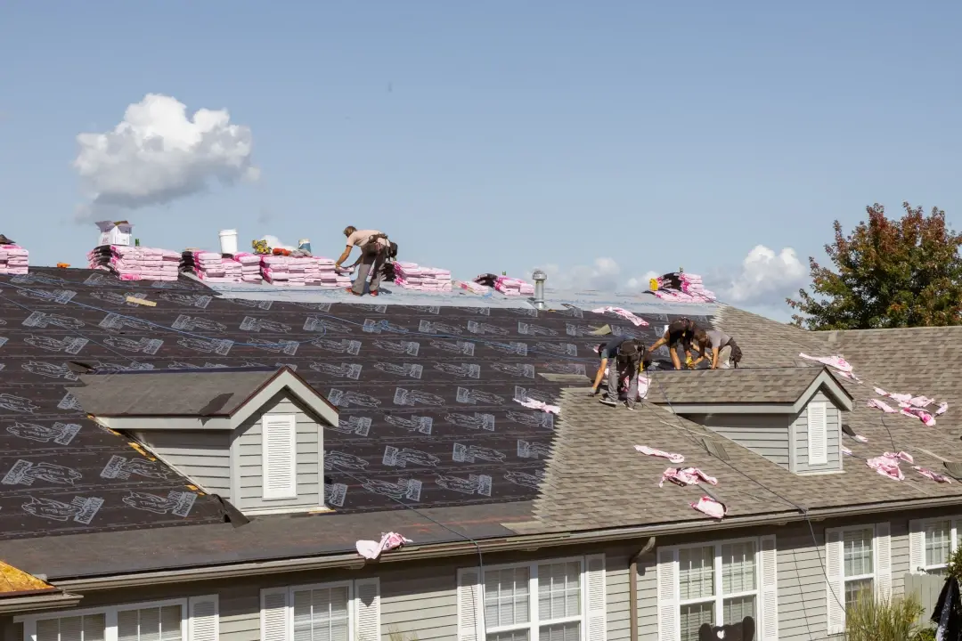 roof crew replacing roof shingles