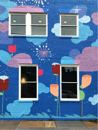Building facade with colorful mural and windows