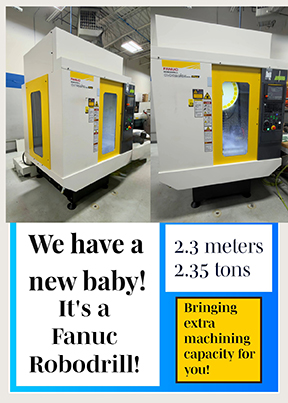 Fanuc Robodrill CNC machine with announcement text stating it is 2.3 meters tall, weighs 2.35 tons, and offers extra machining capacity.