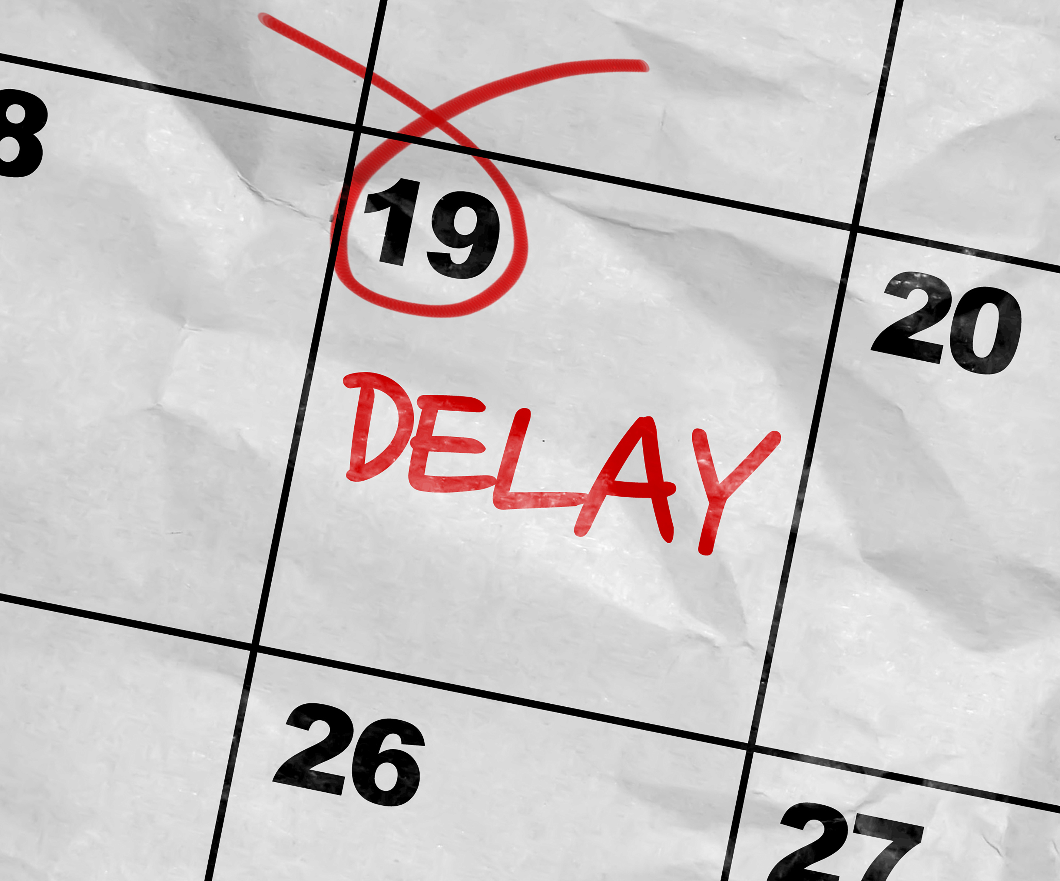 Calendar with the 19th circled in red and red letters saying "DELAY"