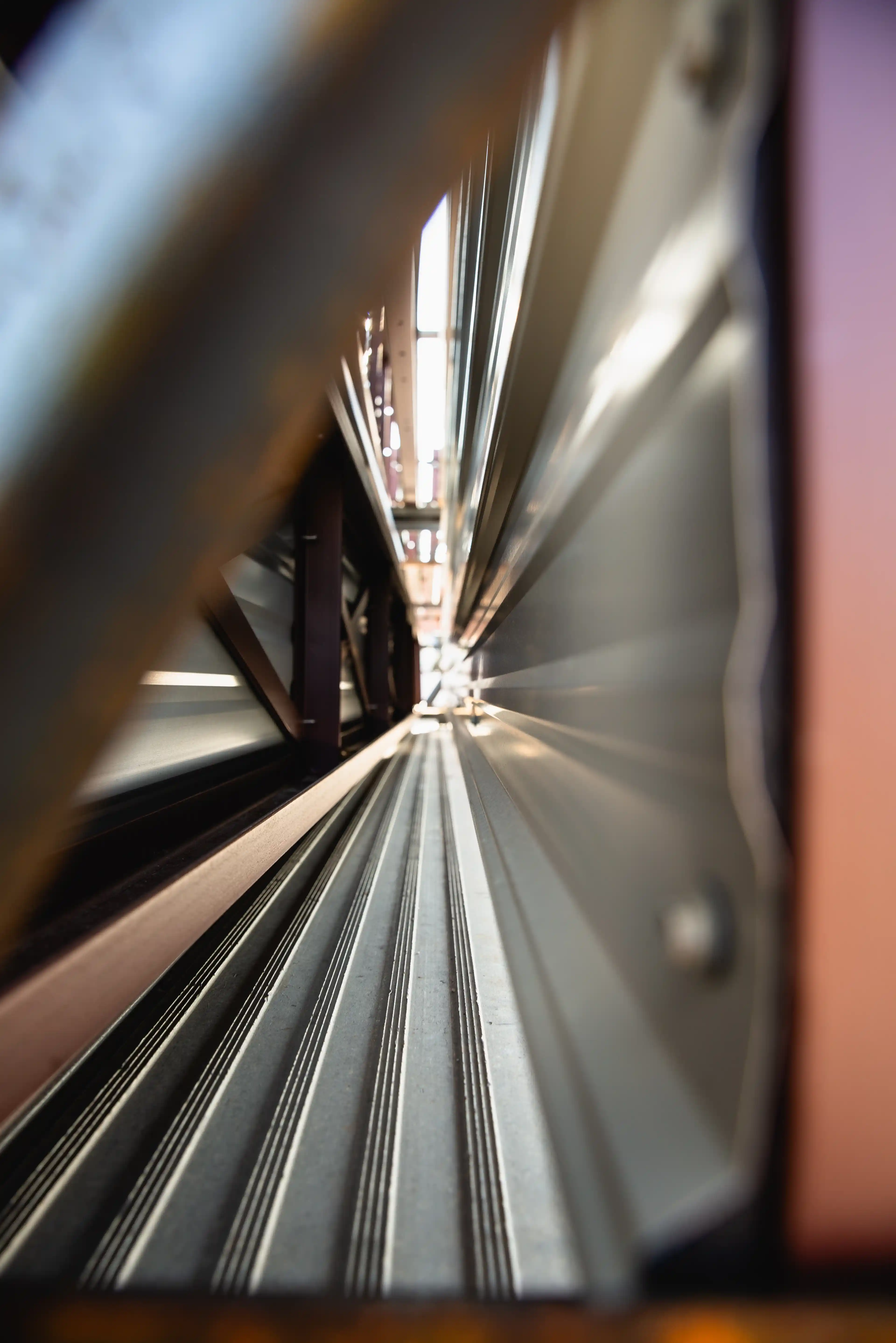 Close-up view of metal beams and panels forming a narrow industrial corridor or structure.