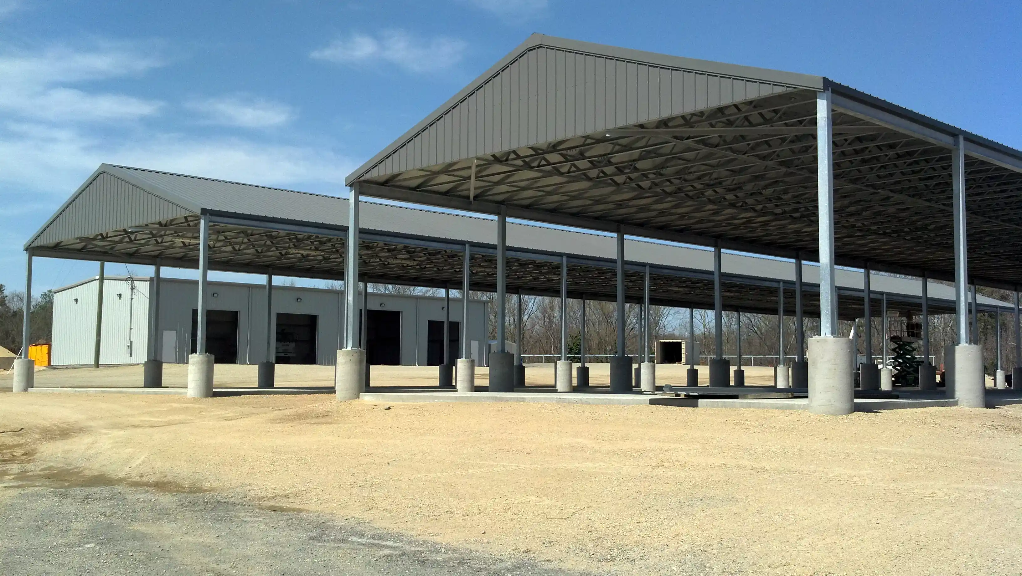 Industrial construction site with scaffolding, metal structures, and workers in safety gear.