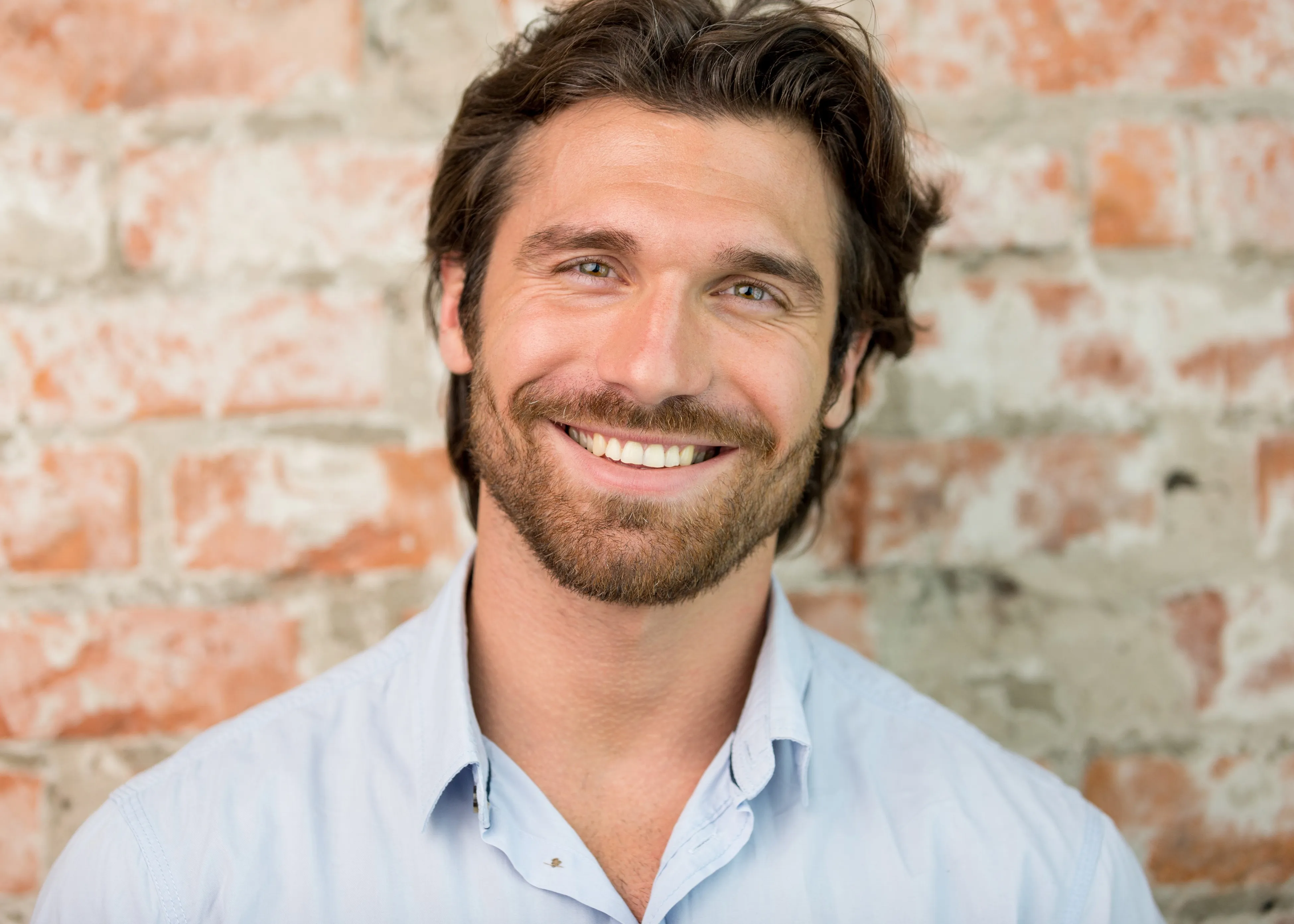 A man with a beard smiling at the camera.