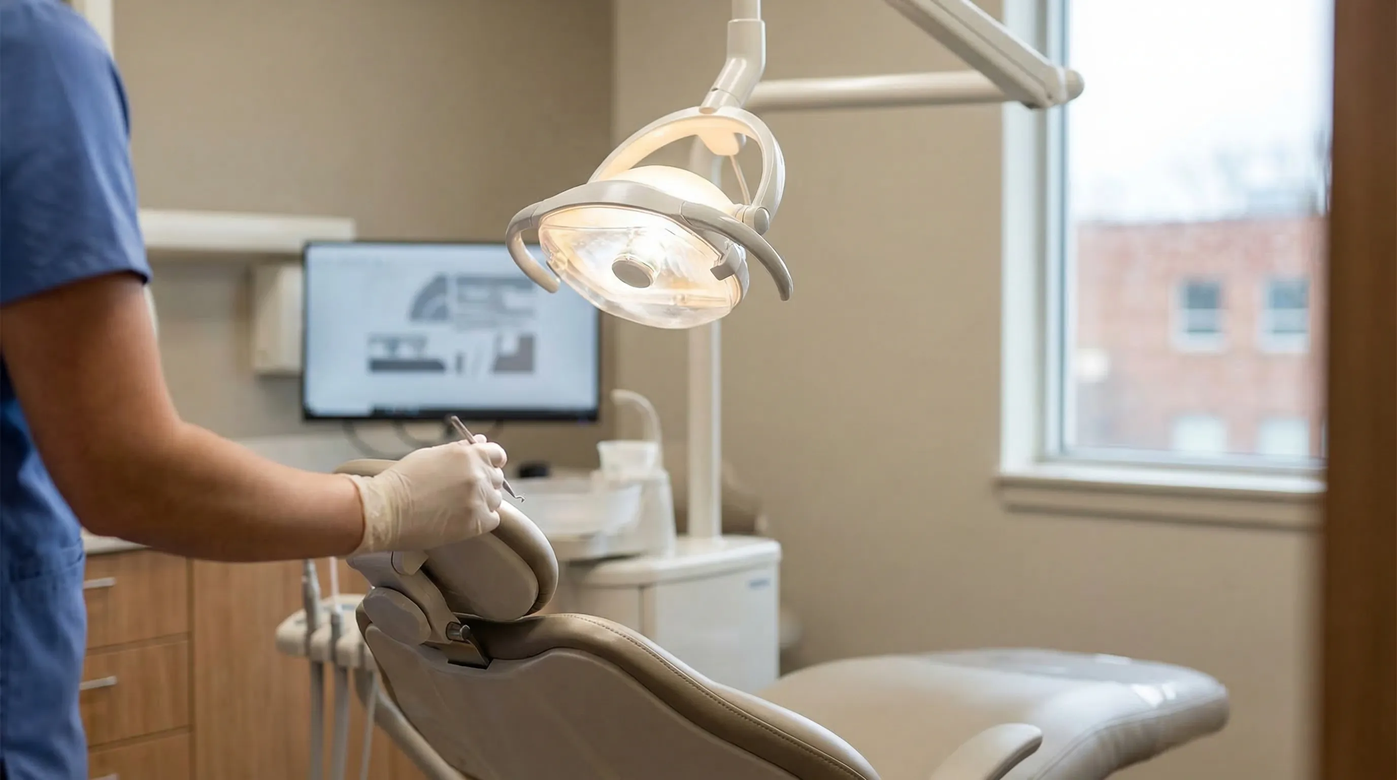 Professional dental office interior with hygienist working with patient in Cincinnati, OH