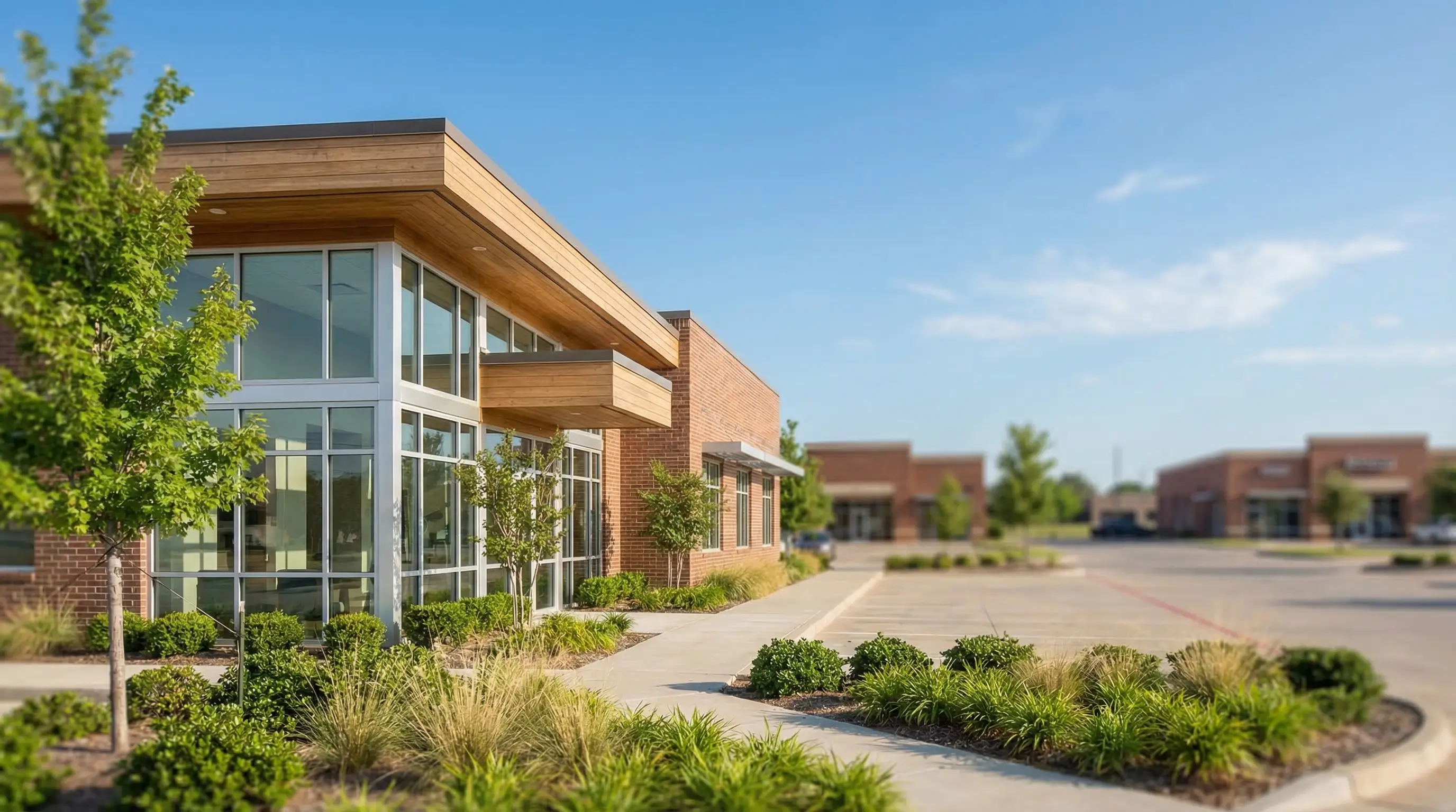 Modern dental office exterior in Tulsa, OK suburban strip — clean professional signage, blue Oklahoma sky, welcoming entrance