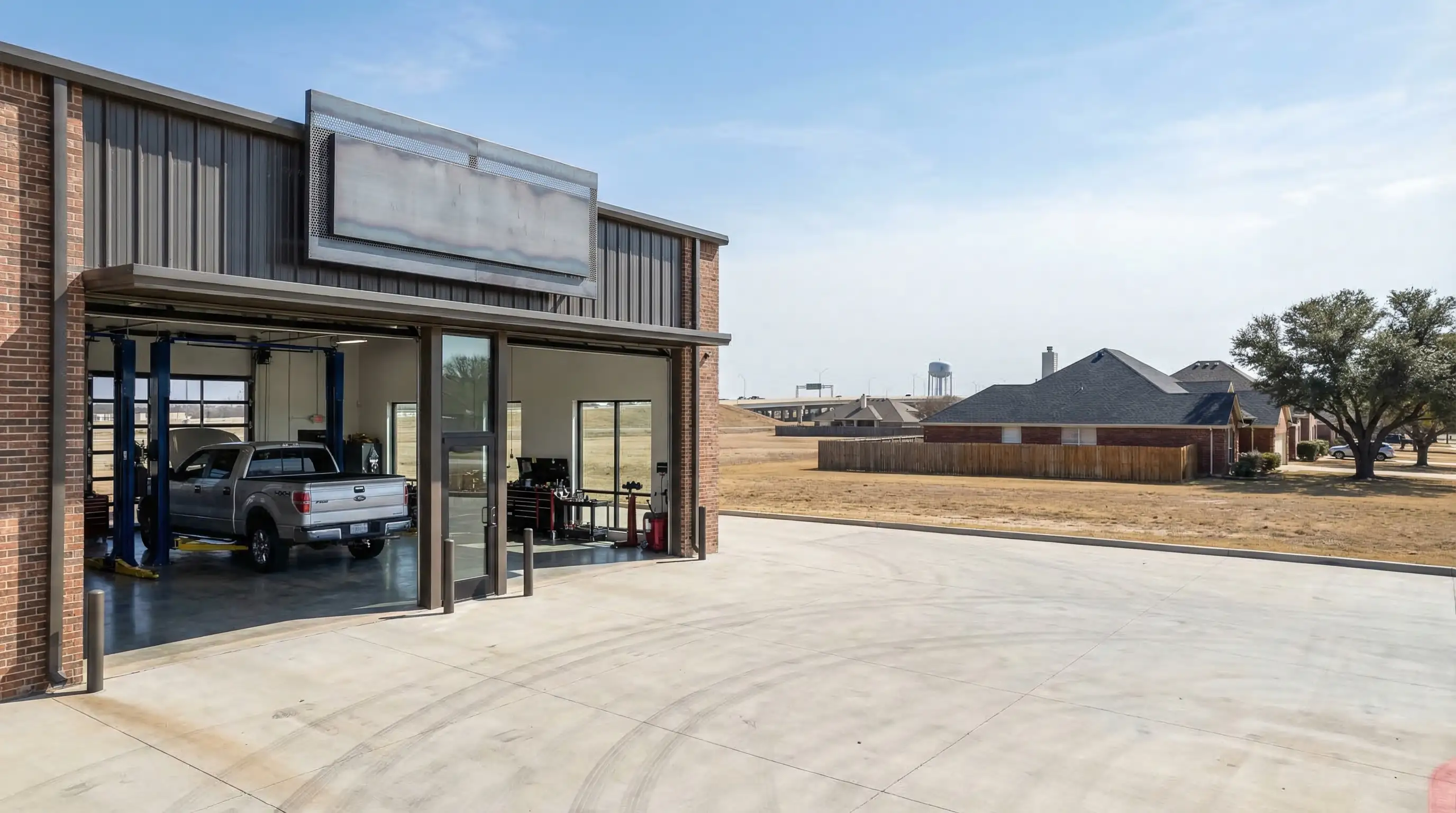 Independent auto mechanic inspecting a full-size SUV on a lift inside a professional Arlington TX auto repair shop
