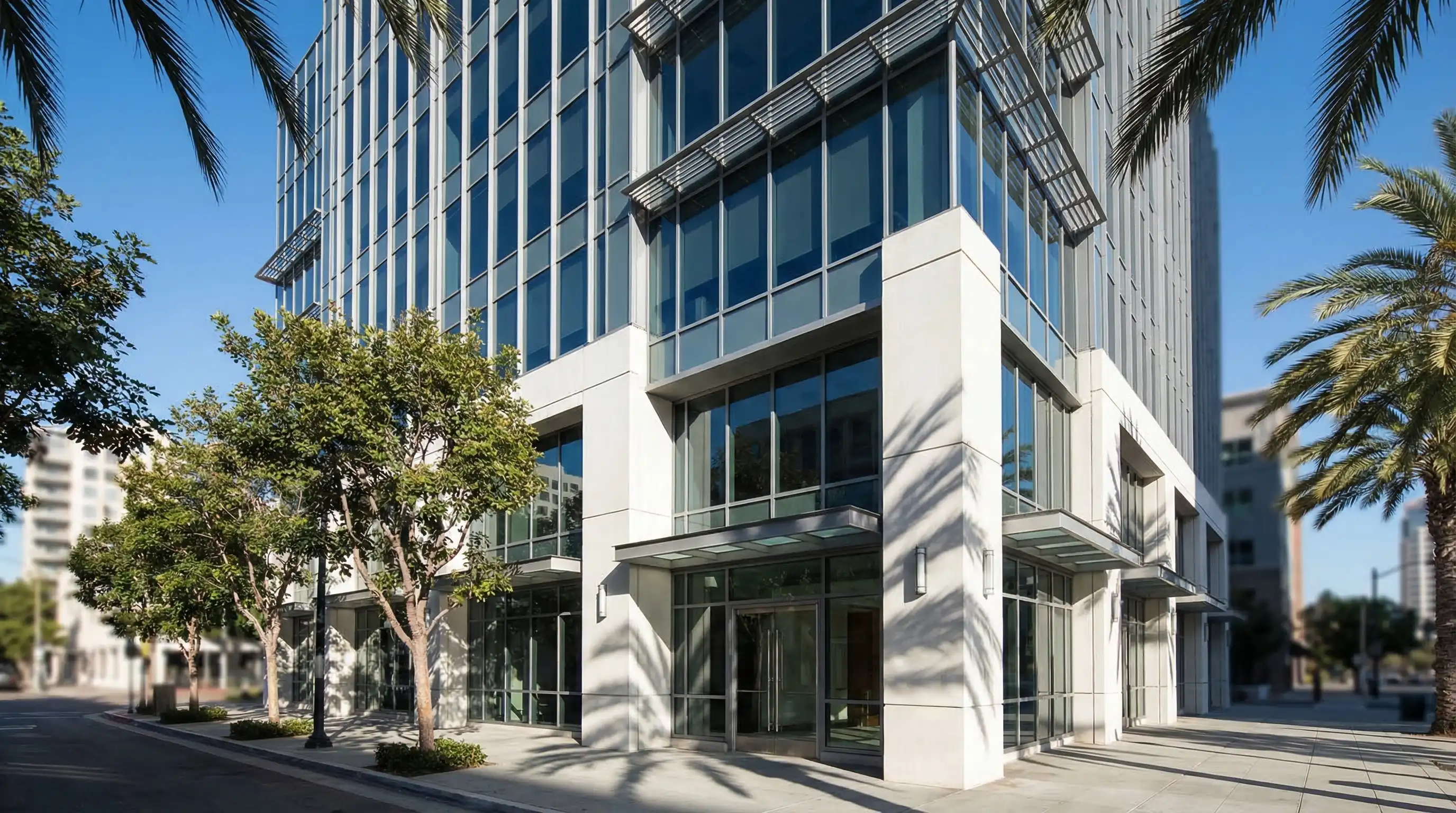 Professional law office interior in San Diego, CA with attorney meeting client across a glass conference table